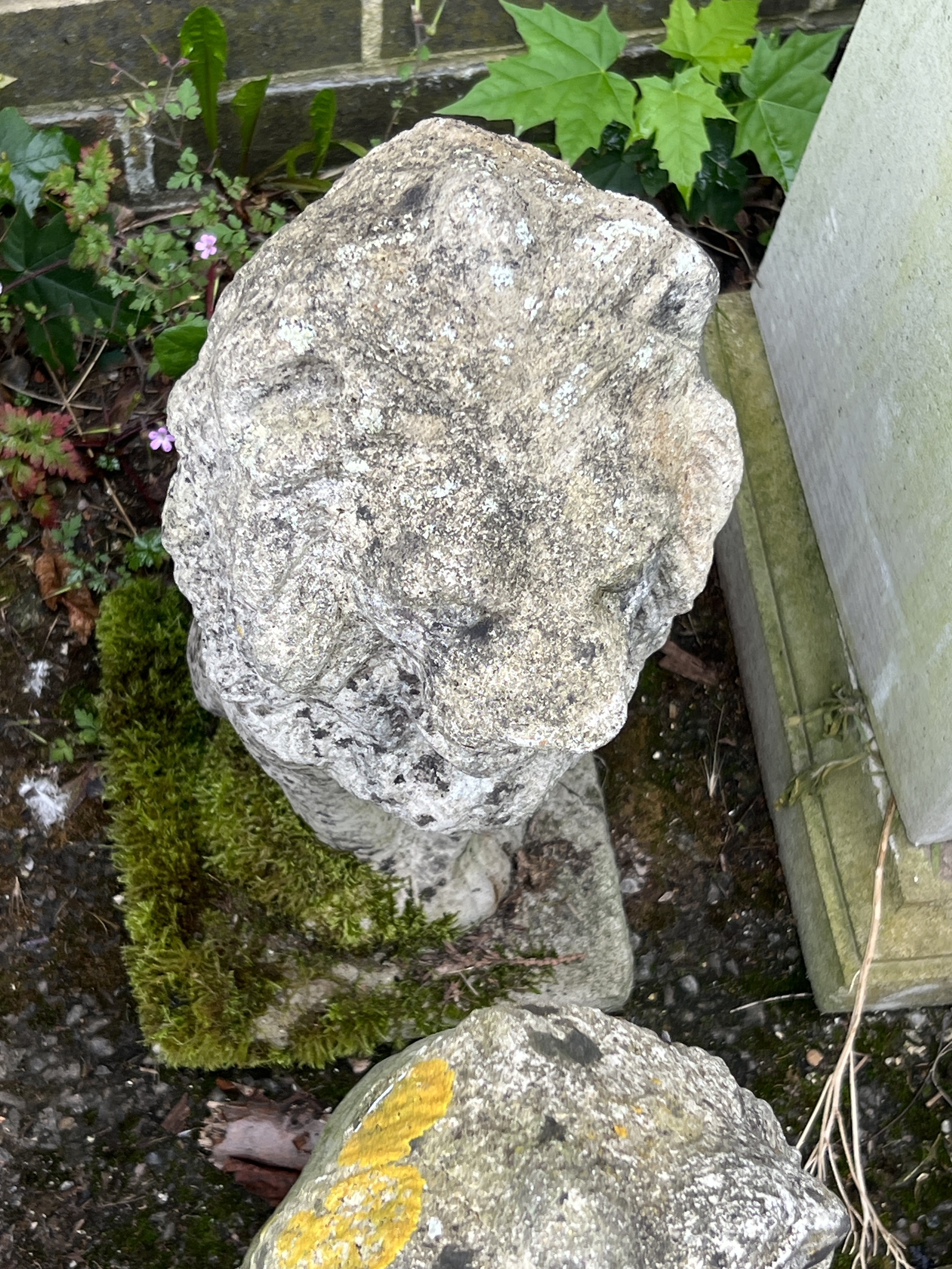 A pair of reconstituted stone seated lion garden ornaments, height 52cm